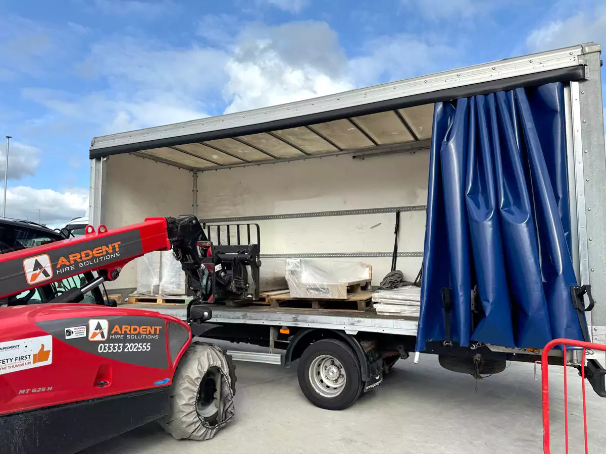 Luton van with curtainside unloading commercial items to a business premises in The Midlands via fork lift